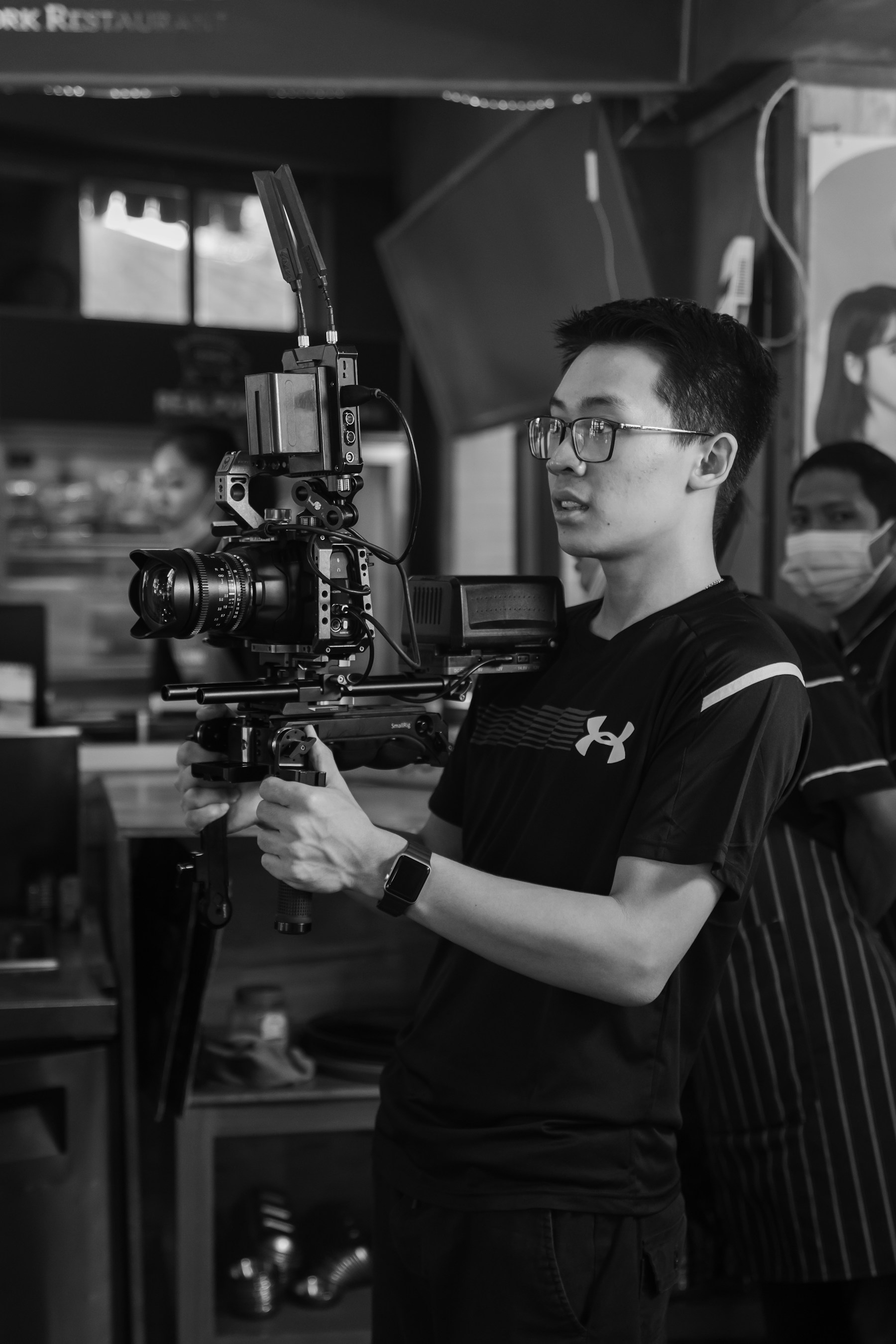 A filmmaker concentrating behind a camera