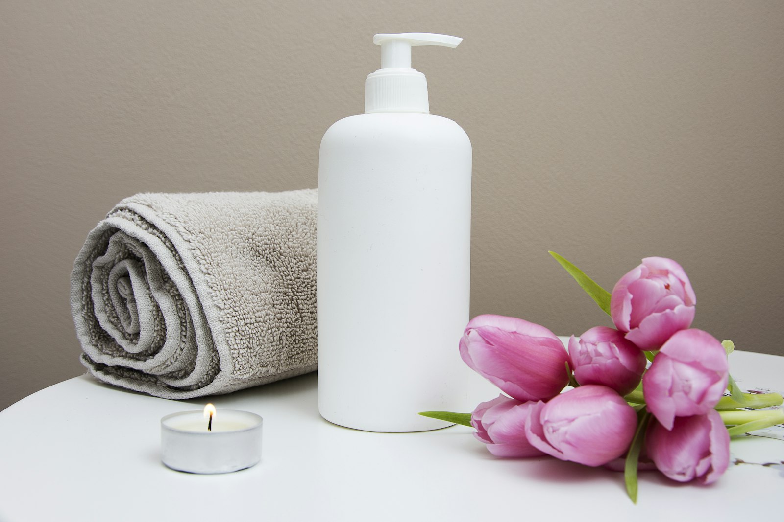 Candle, towel and fresh tulips