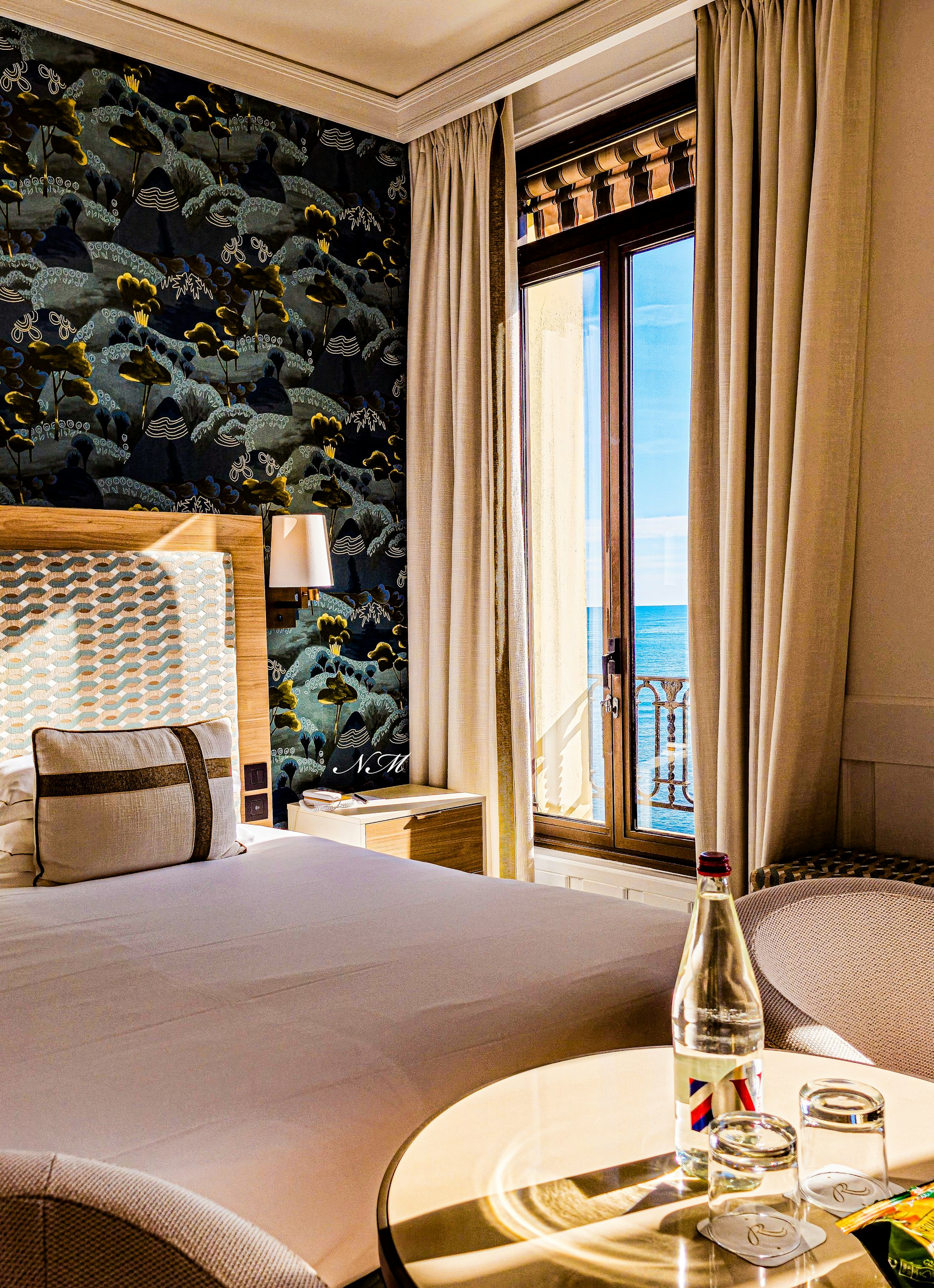 Quiet hotel room beside a large coastal window