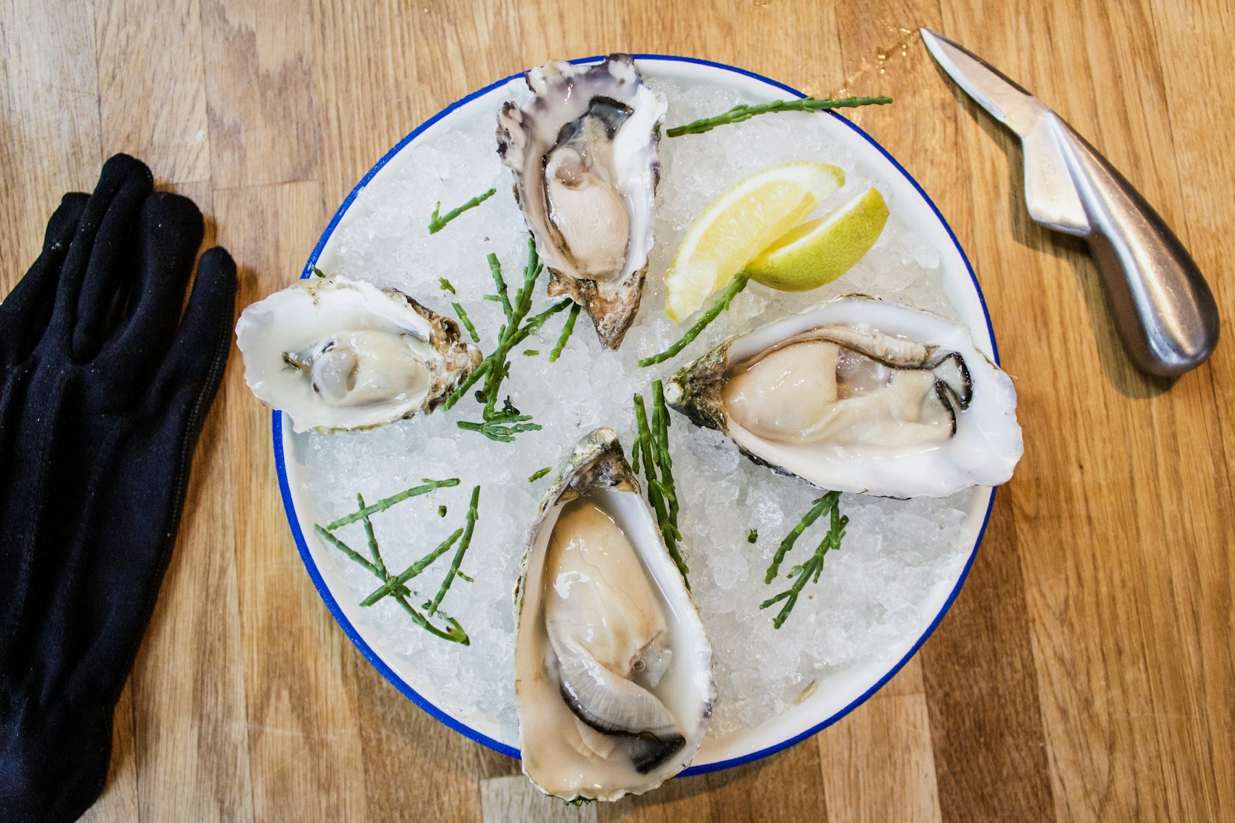Oysters and lemon served on a ceramic plate